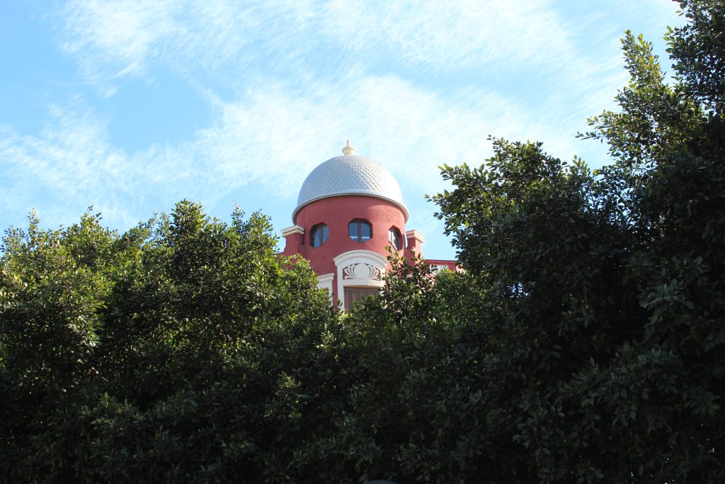 Enrique Nieto's terracotta domed apartment building in front of leafy trees in central Melilla