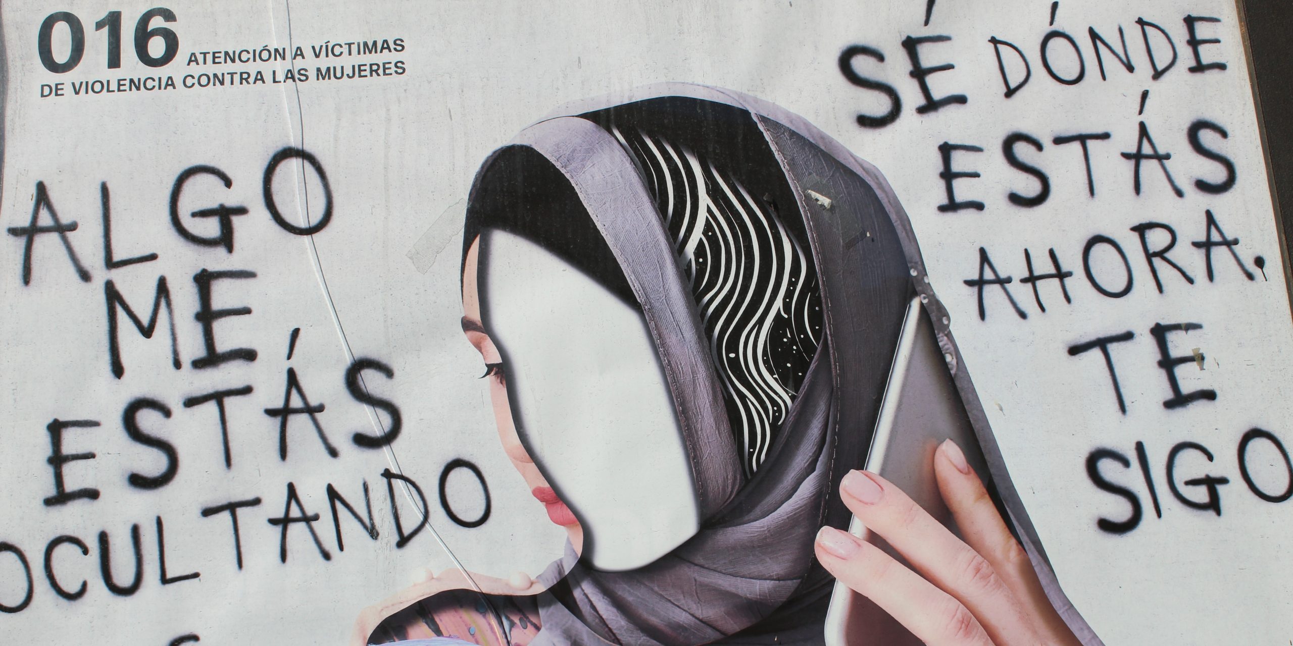 Public service announcement poster in Melilla depicting a Maghrebi woman and the 016 helpline number
