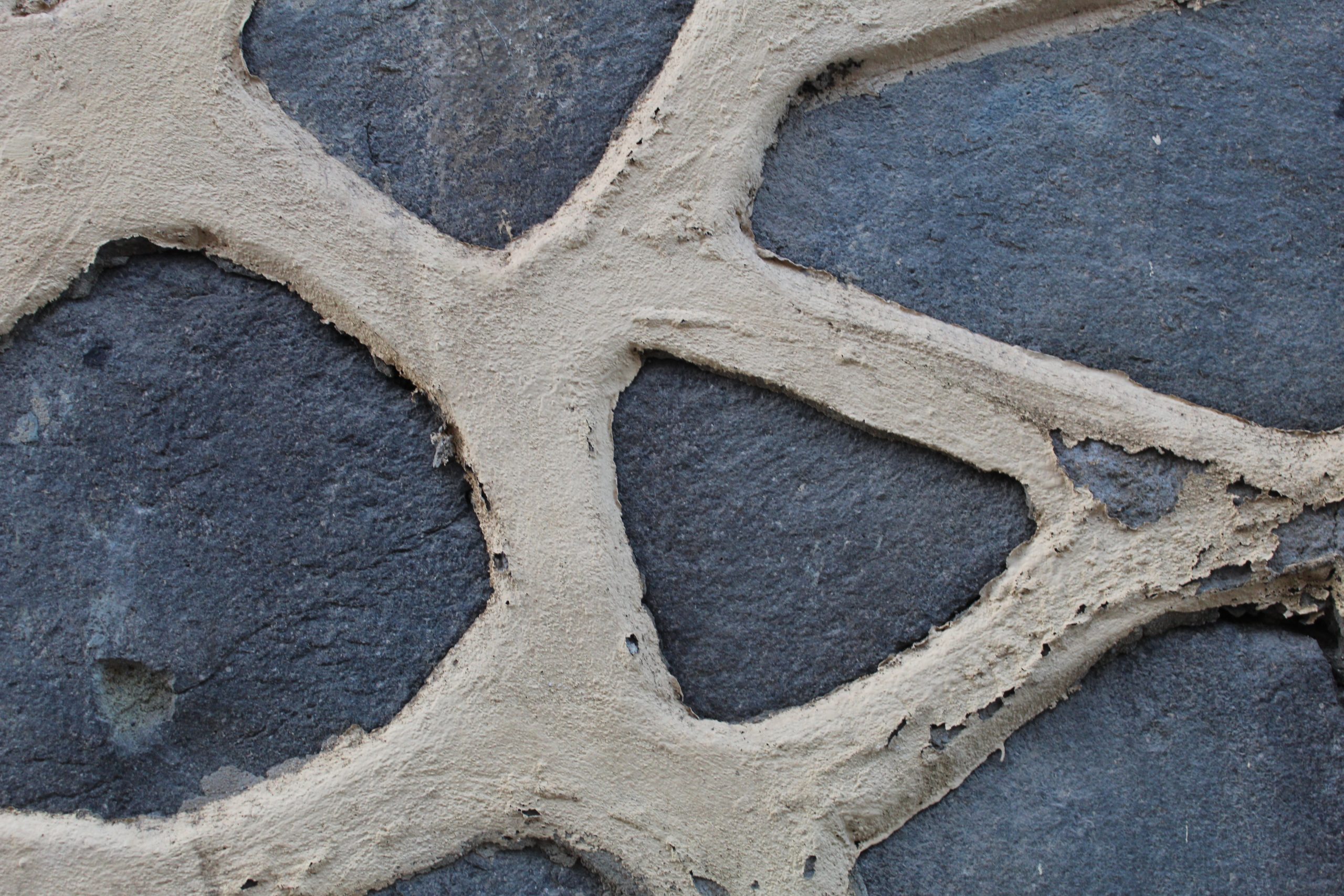 Spanish wall in Melilla made of grey stones with thick lines of whitish mortar