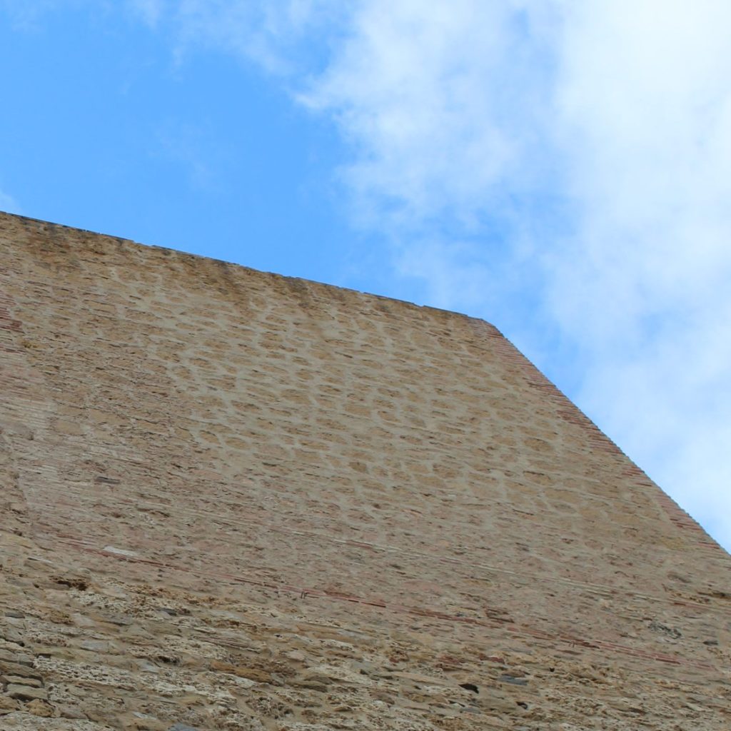 Towering stone beachside fortress base for Melilla.travel